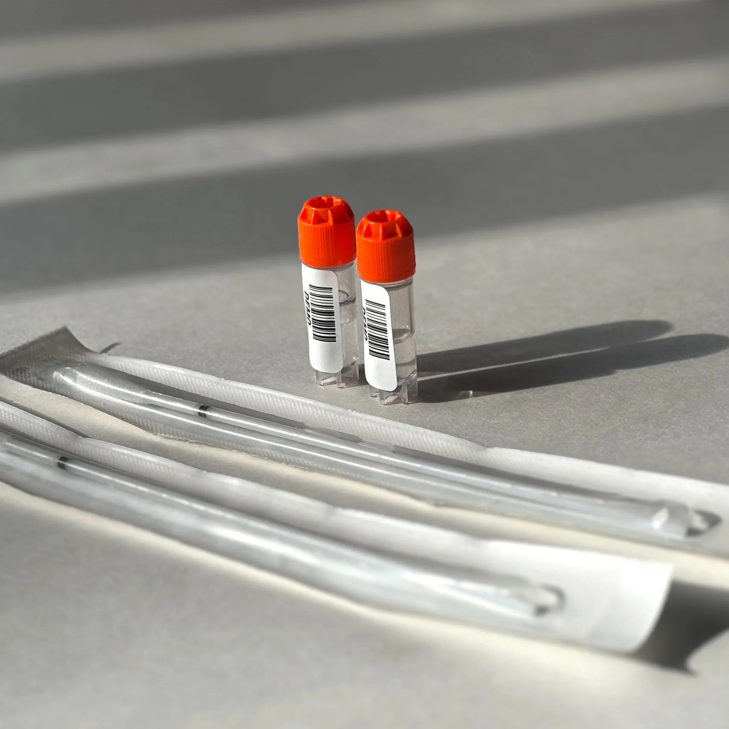 Two vials with orange caps and syringes for wellness support, clinically proven formula