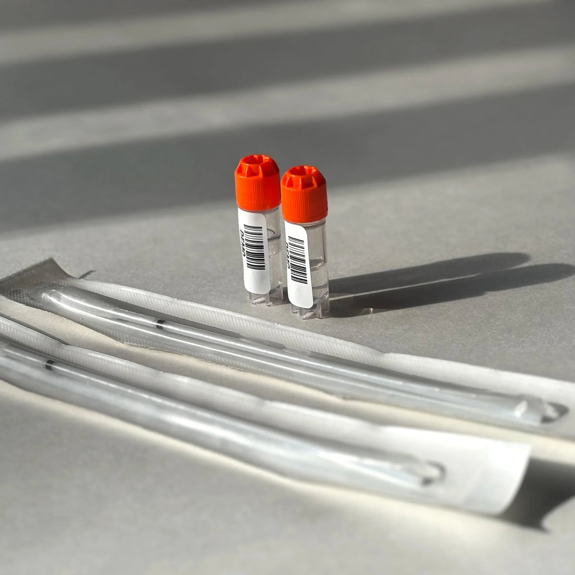 Two vials with orange caps and syringes for wellness support, clinically proven formula
