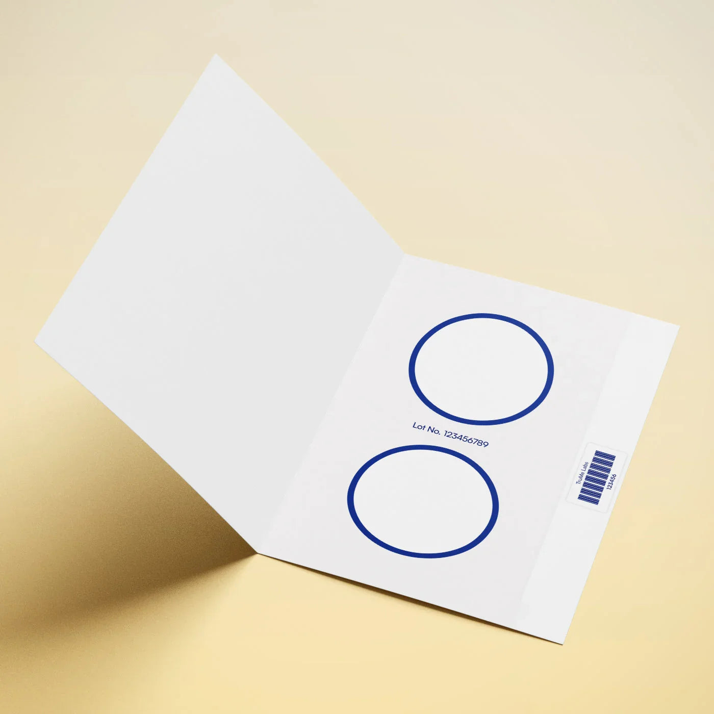 White booklet with blue circles, lot number, and barcode on cream background